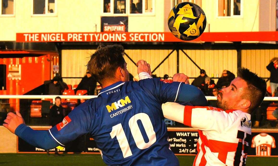 Danny Walder, of Herne Bay, and Sheppey striker Alex Willis battle it out in the air during Saturday’s 2-2 draw at Holm Park. Picture: Marc Richards