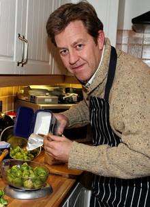 Mike Burton Phillipson in his kitchen creating his sprout cake recipe.