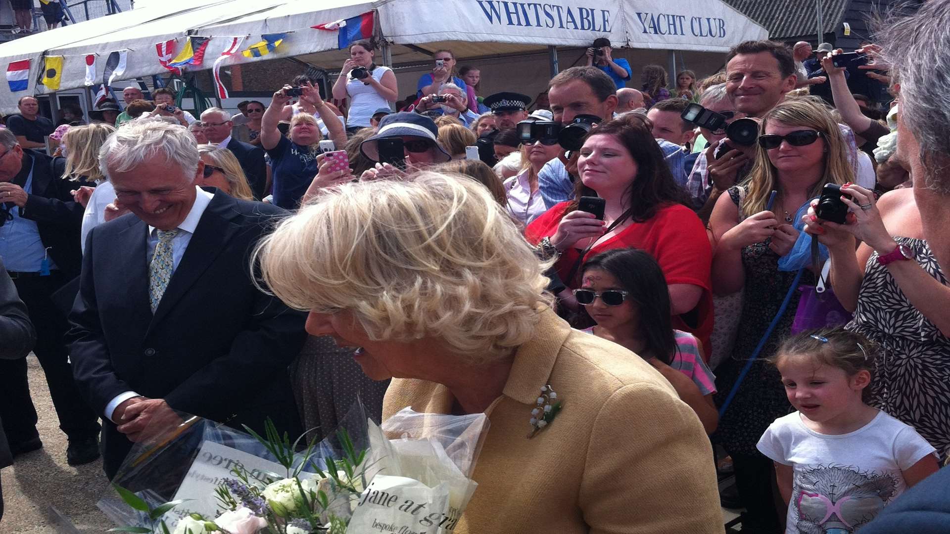 Camilla receiving a bouquet