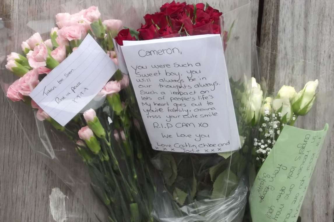 Floral tributes honour Cameron Tidey at the spot where he fell from a roof in Ramsgate. Picture: Mike Pett