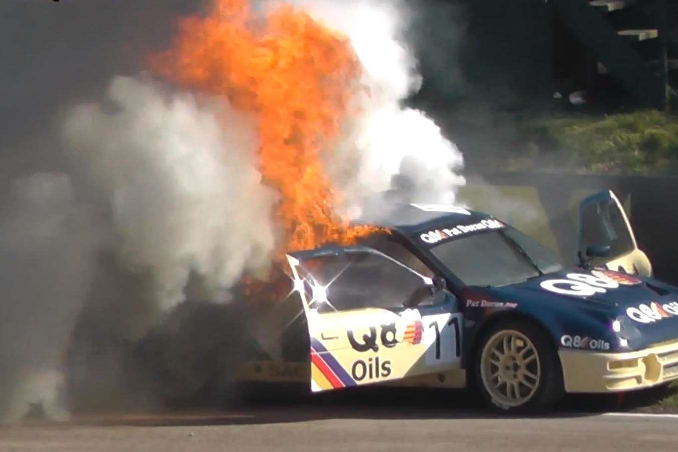 The doors of Pat Doran's blazing car fly open. Picture: allthekasparas/YouTube