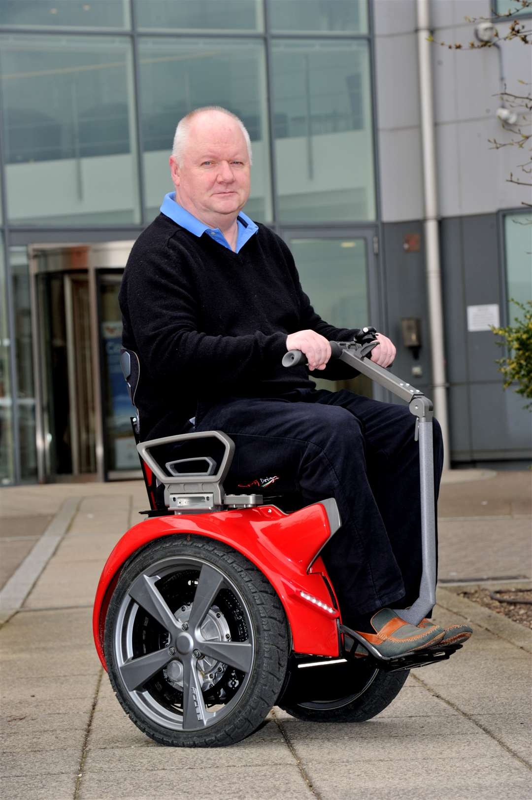 Craig sitting in the new-style mobility wheelchair
