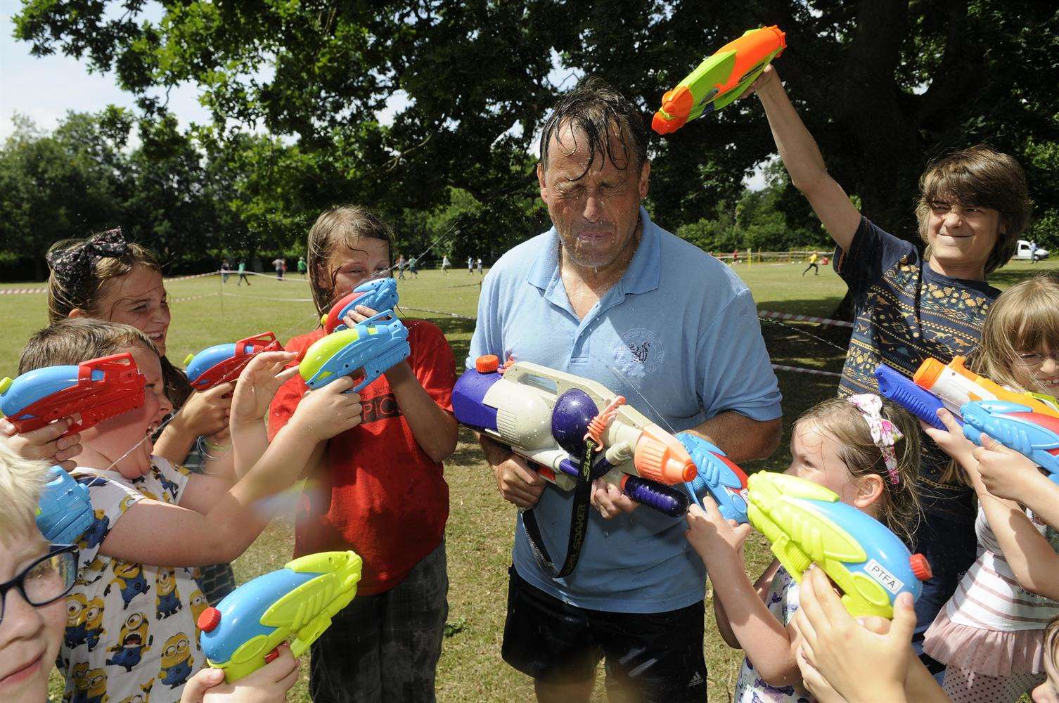 Godinton Primary head teacher Jim Holditch gets a soaking from pupils