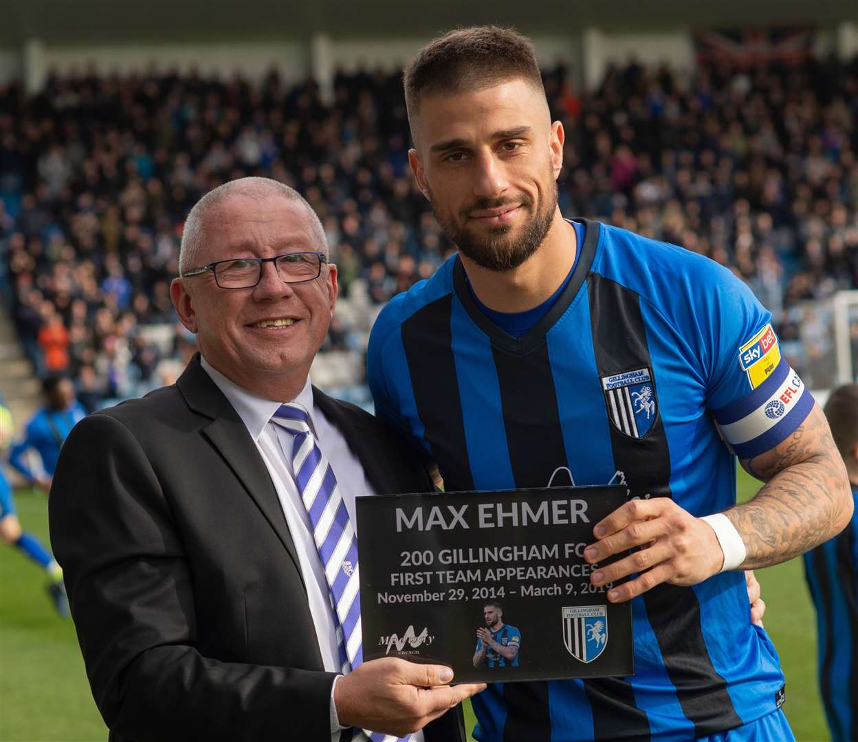 Chairman Paul Scally presents a plaque to Max Ehmer on his 200th game for Gillingham Picture: Ady Kerry