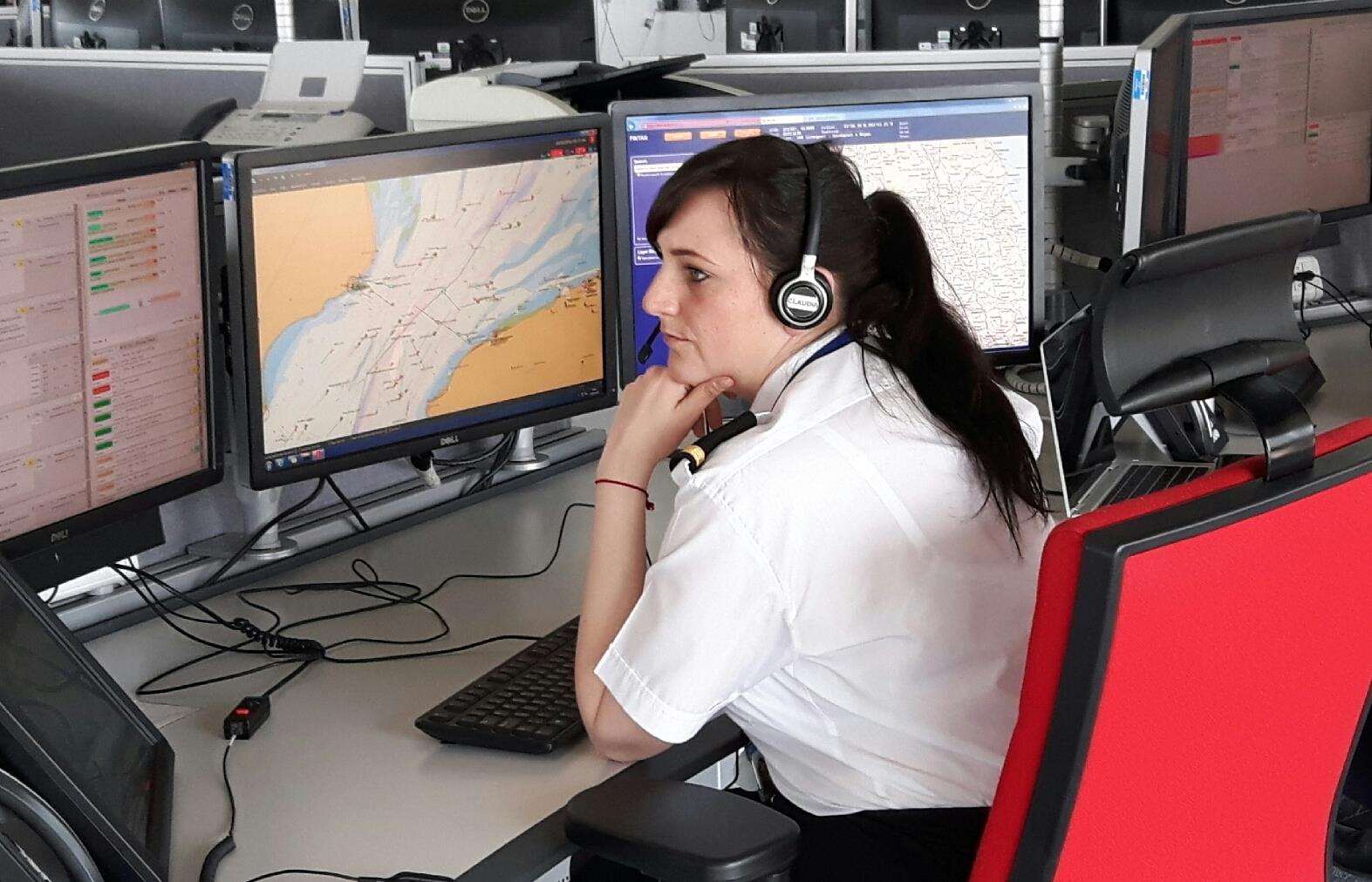 A coastguard worker monitoring screens for emergency alerts