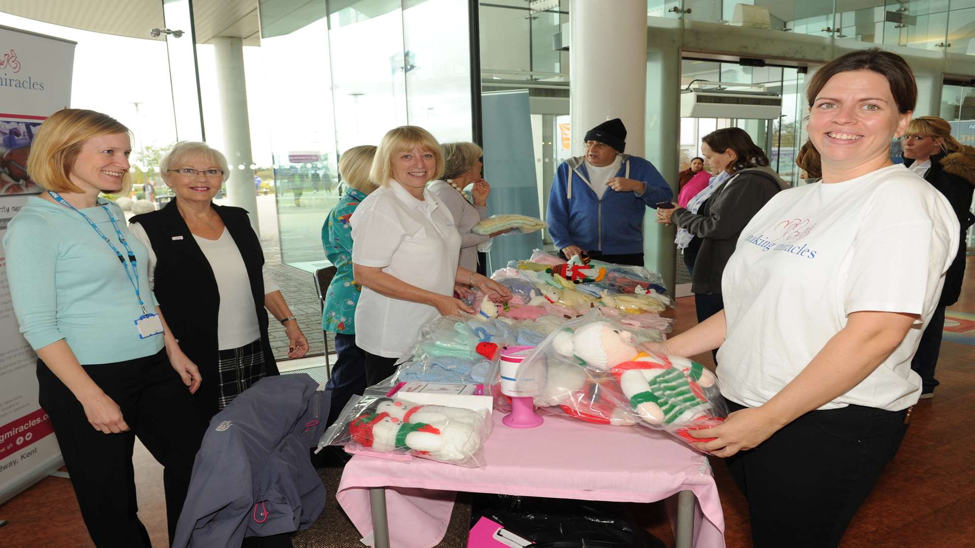 Darent Valley Hospital, Dartford. New Making Miracles charity stall in reception, Kelly Wells (right)