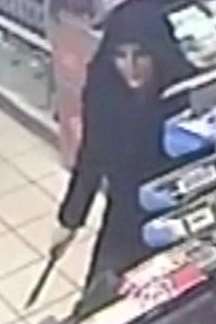 Hooded robber Anna Chambers wields a knife at Murco in South Ashford