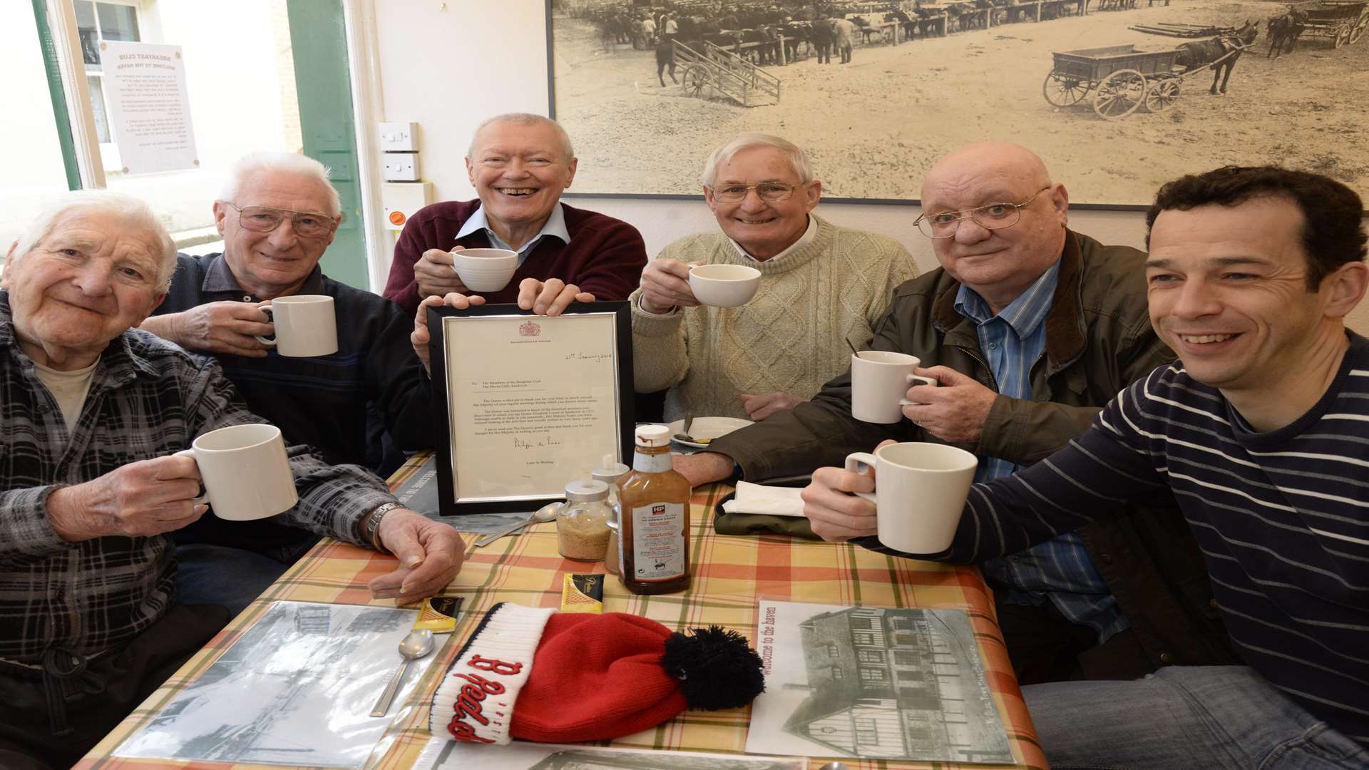 Clay Sluder, Charlie Bourner, Ron Coleman, Jim Minnock, Jim Pevy and Barry Hopkins, members of the Haven Cafe Breakfast Club, with their letter from the Queen. Picture: Chris Davey