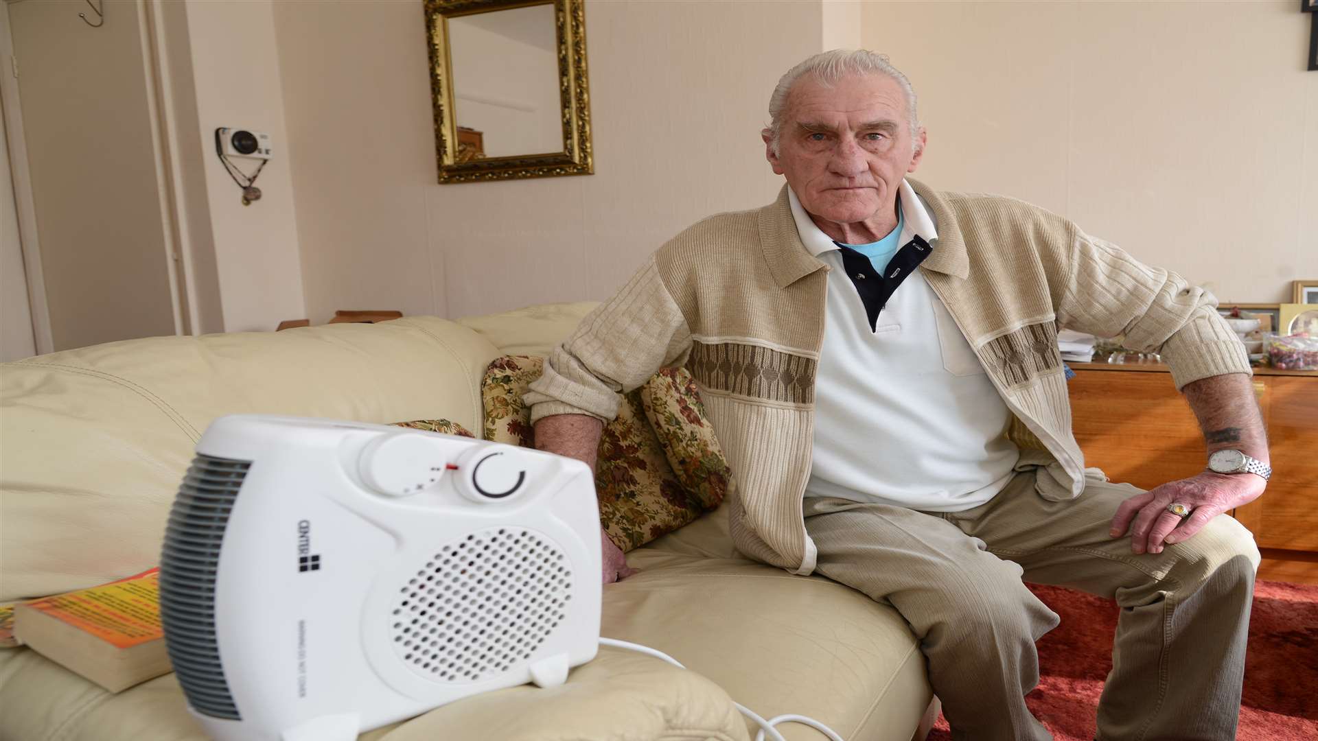 Mr Burt with the temporary heater he was supplied with to heat his home. Picture: Gary Browne