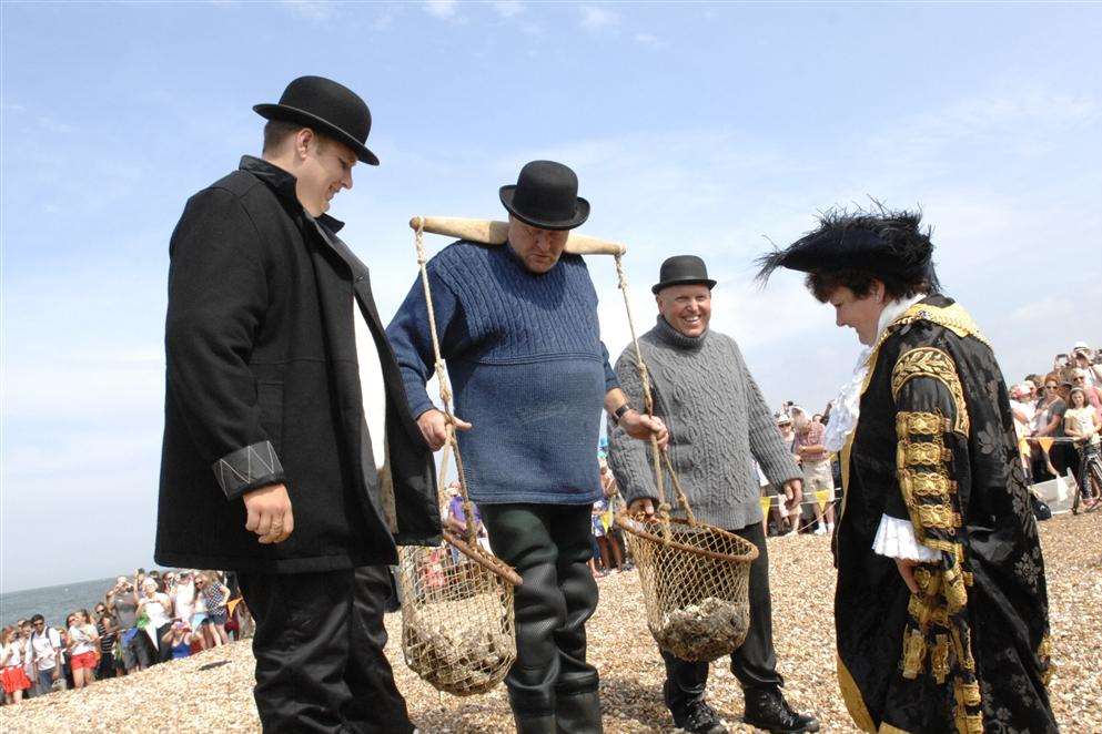 Lord Mayor of Canterbury Cllr Heather Taylor greets the 'dredgermen' during the landing of the oysters at the Whitstable Oyster Festival on Saturday. Picture: Chris Davey