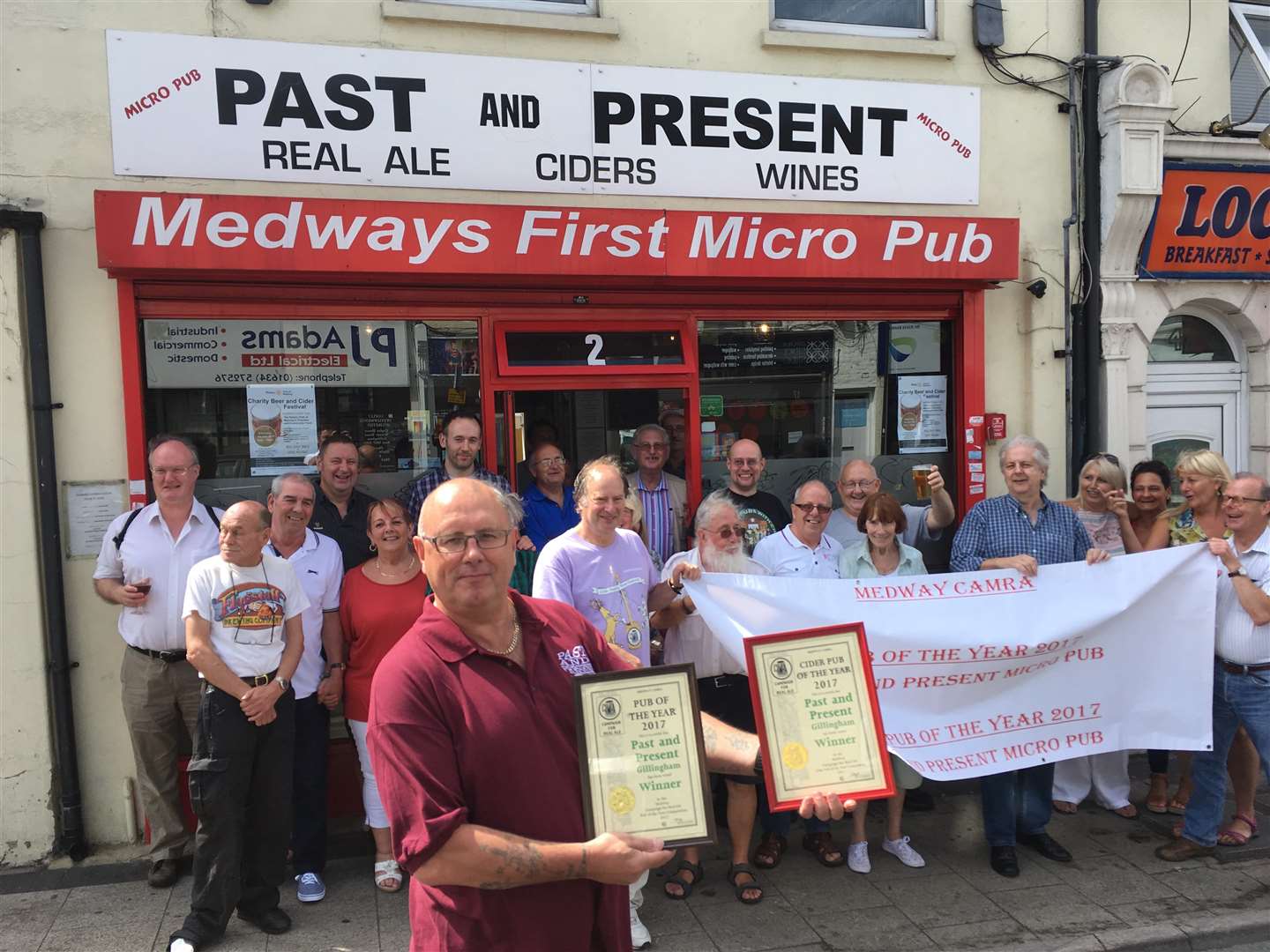 Past and Present micropub landlord Dave Hallowell shows off the awards from CAMRA for Medway's best pub and best cider pub