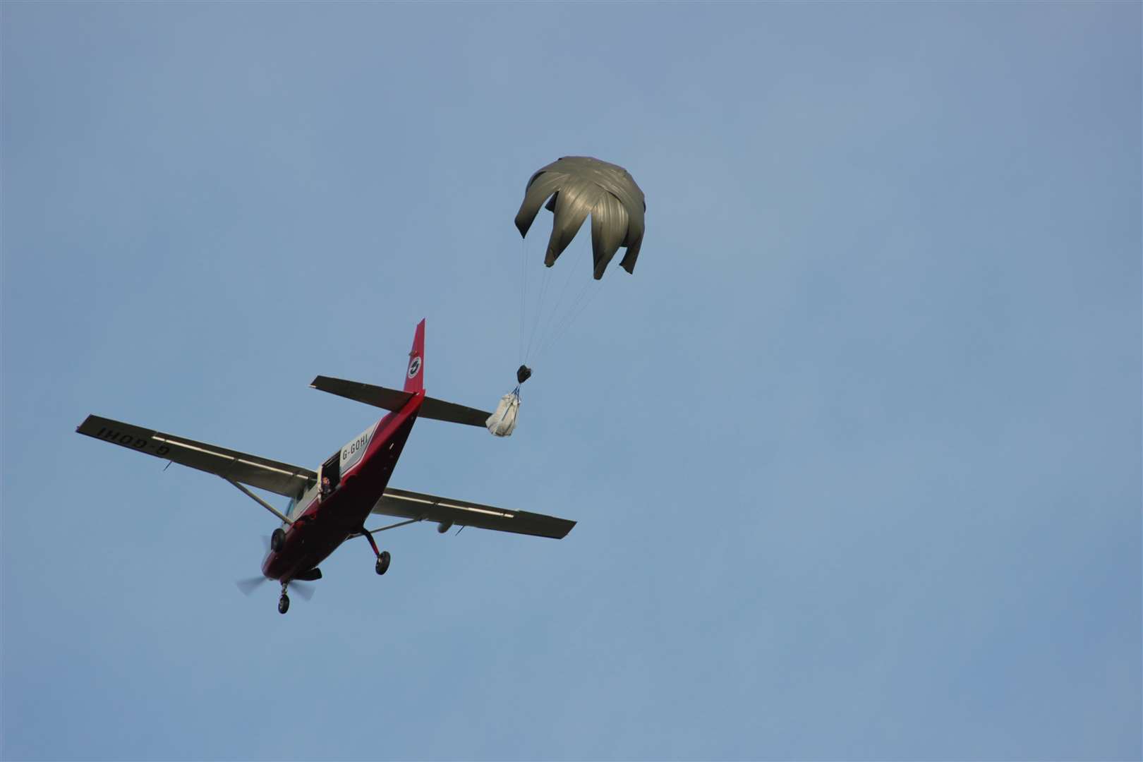 Air Drop Box packages are dropped from a plane by parachute during testing at Headcorn Aerodrome