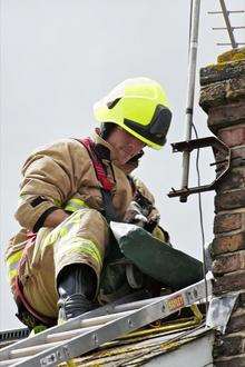 Firefighter Dan Godley rescues the cat