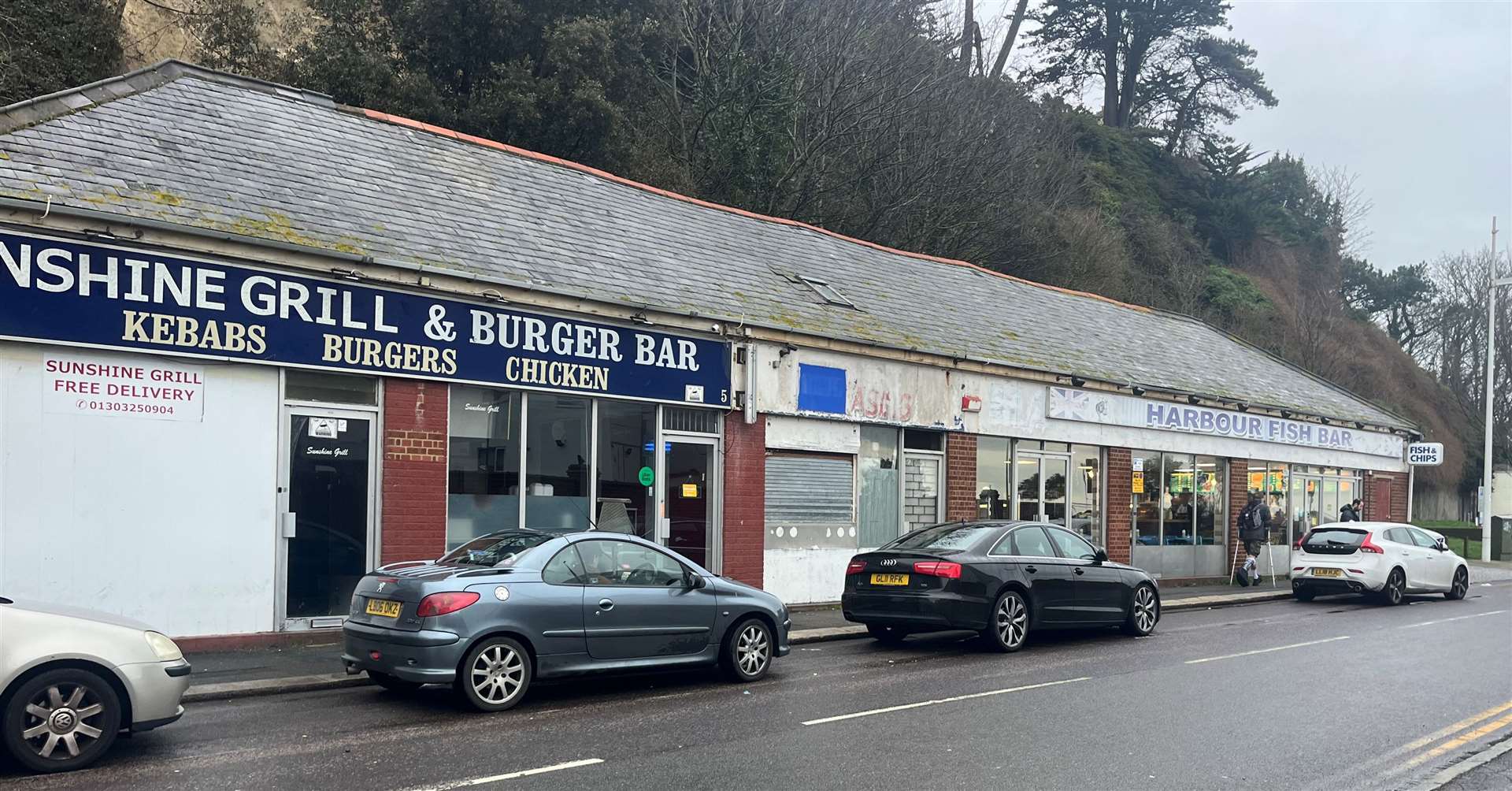 A parade of shops on Lower Sandgate Road where the Harbour Fish Bar remains open after only experiencing minimal damage in the recent landslides