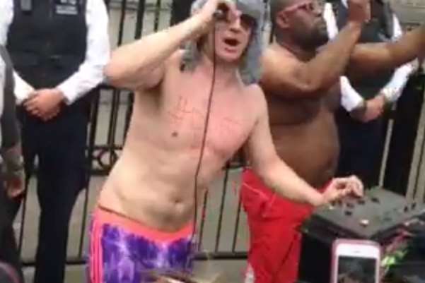 Police watch as Disco Boy Lee Marshall dances in Downing Street