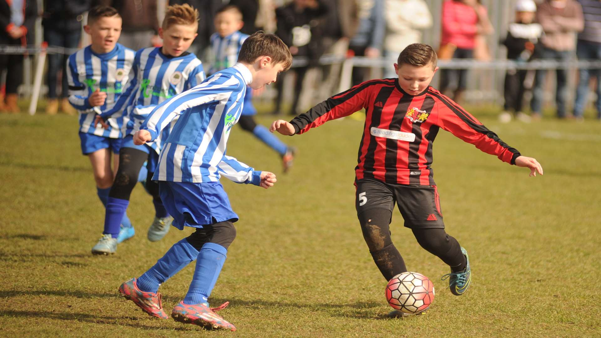 Woodcoombe Youth (red and black) and Oak Athletic battle for superiority in the Under-9 Championship Cup final Picture: Steve Crispe