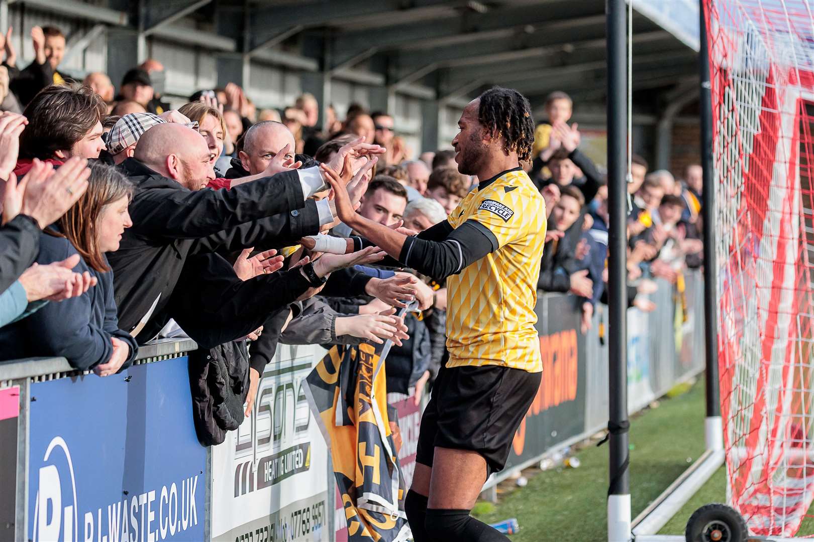 Lamar Reynolds celebrates with Maidstone fans at full-time. Picture: Helen Cooper
