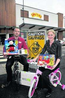 Smyths' assistant manager Matthew Rangely and manager Catherine Leetch get on their bikes to promote the new toy scrapage scheme at the store