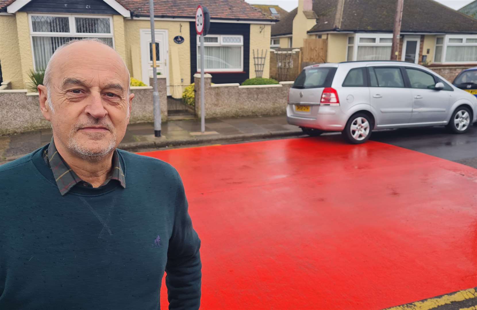 Retired policeman John Sheering says the 20mph red warning markings outside his home are unnecessarily excessive