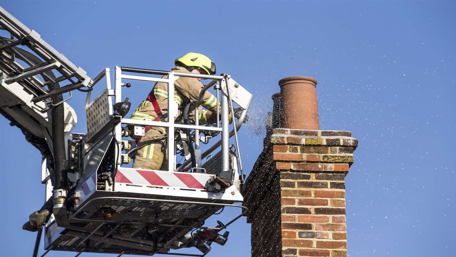 Firefighters tackle a chimney fire. Stock image