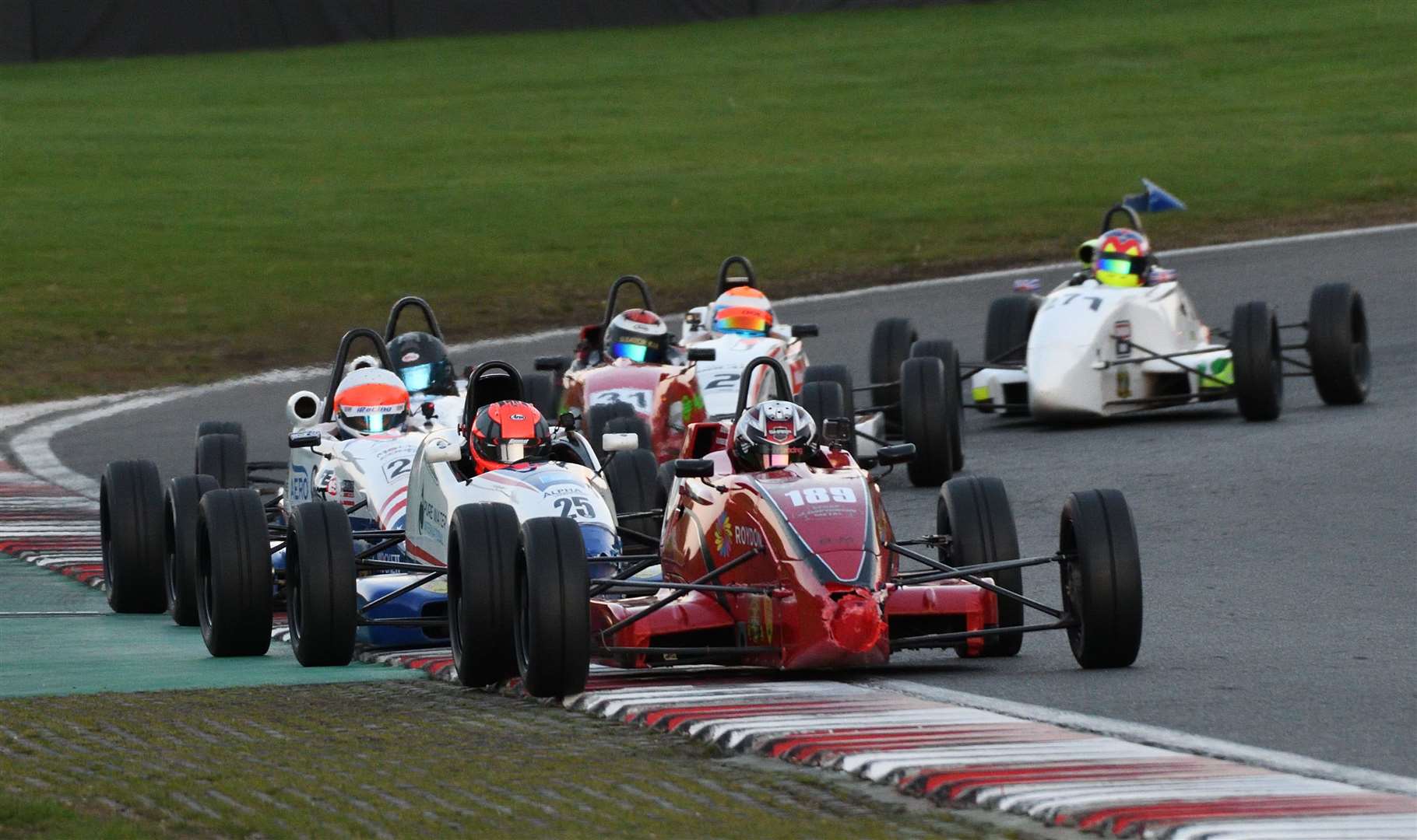 Sharp scored his first Avon Tyres National Formula Ford Championship victory at Anglesey earlier this year; he's pictured leading a train of cars through Graham Hill Bend during Sunday's final. Picture: Simon Hildrew