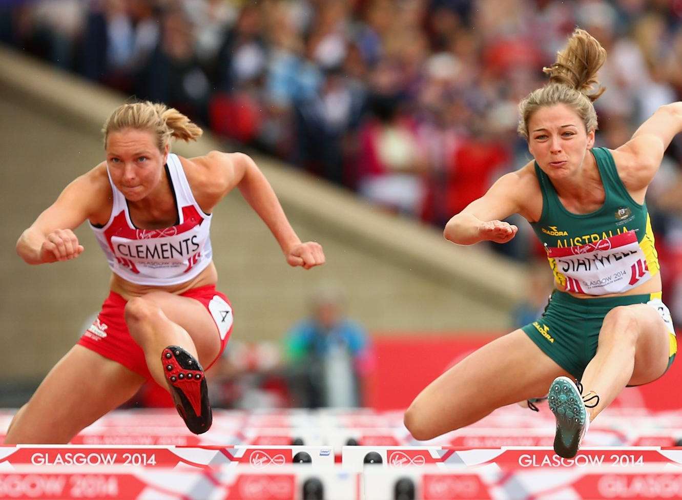 Grace Clements, left, and Sophie Stanwell of Australia compete in the women's heptathlon 100m hurdles at the Glasgow 2014 Commonwealth Games. Picture: Cameron Spencer/Getty Images