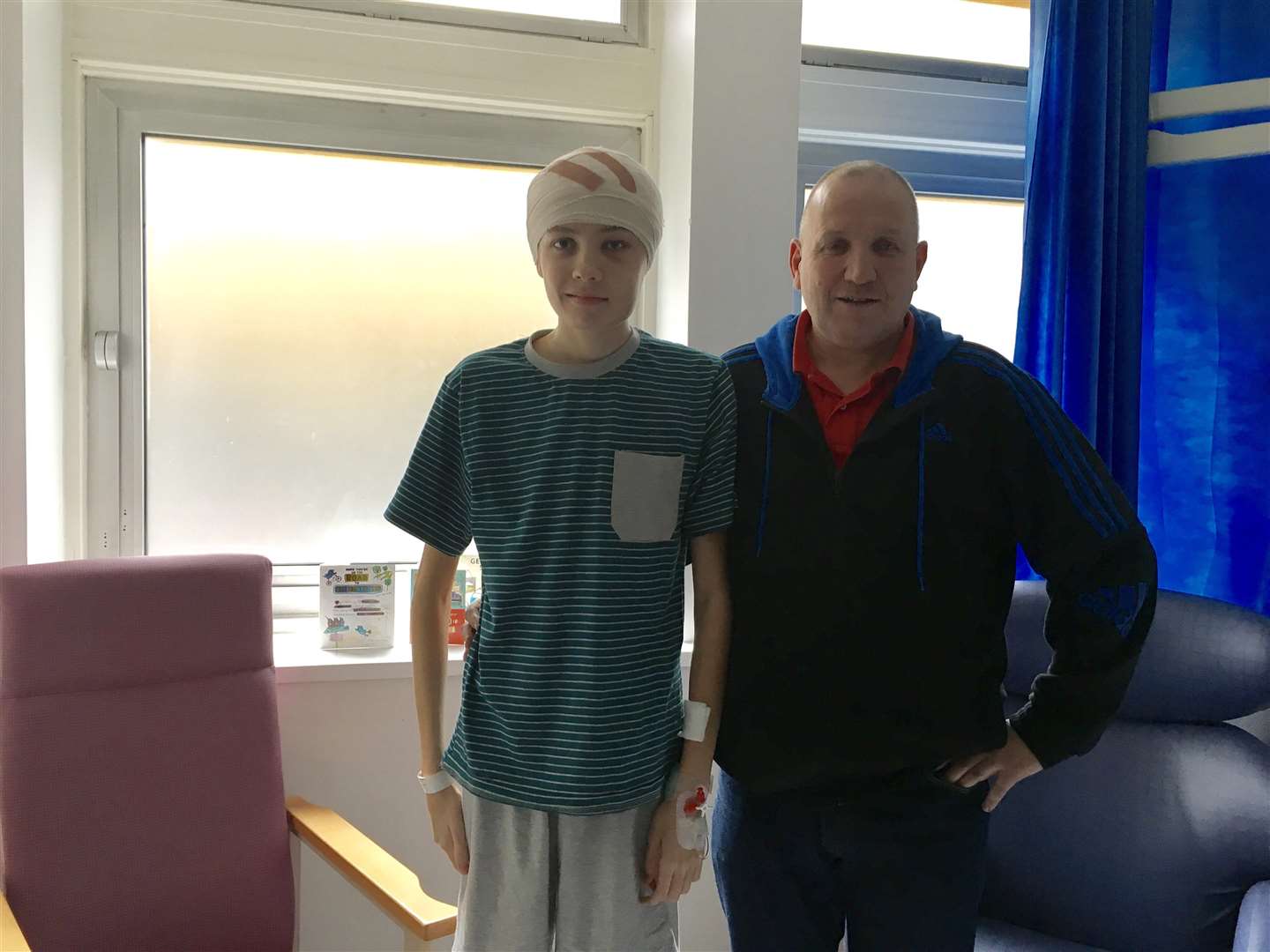 Jayden Powell's life was saved when a brain tumour was found after a check up at an opticians at Tesco. Pictured with his father Steve