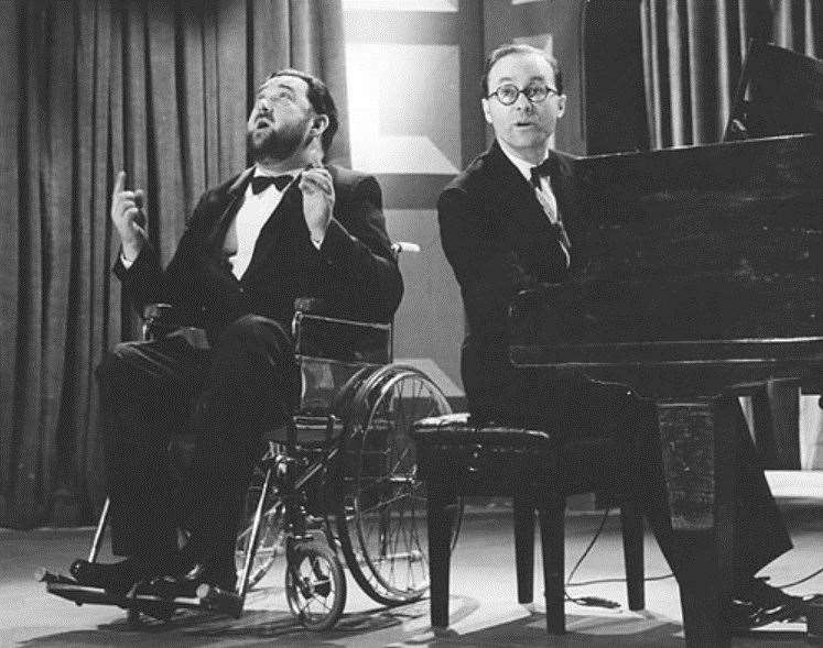 Michael Flanders, left, and Donald Swann at the piano on stage