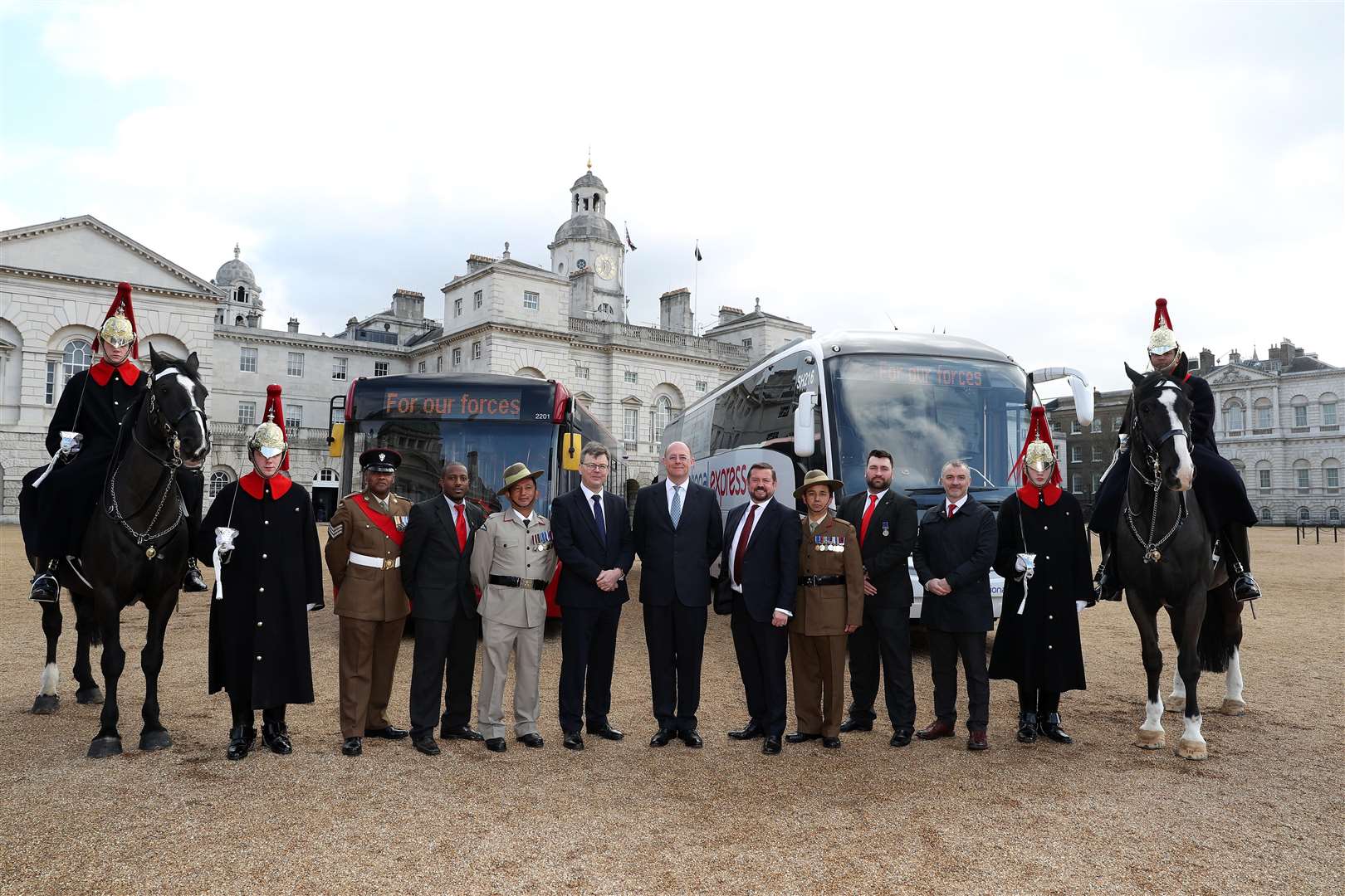National Express Group bosses flanked National Express employees who formerly served in the forces and members of the Blues and Royals cavalry regiment, at Horseguards in London.
