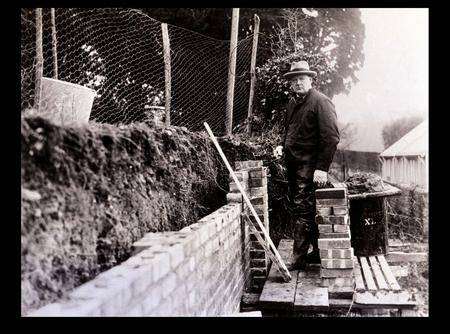 Building a brick wall at Chartwell House, around 1930. Picture: Mirrorpix.