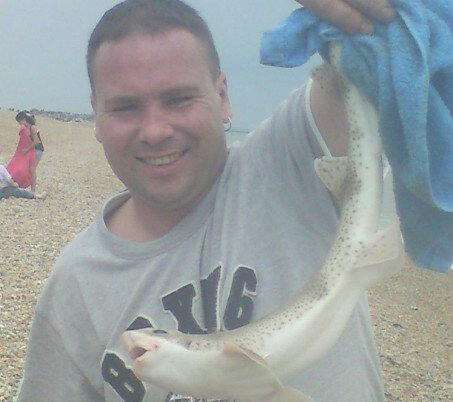 On a trip to the beach, Mark Tennyson-Smith poses with a fish