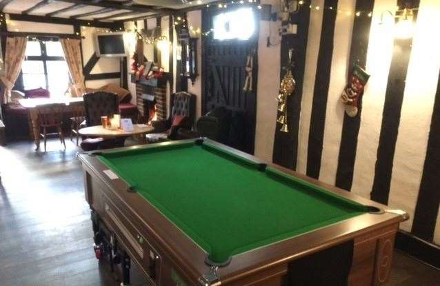 As you walk in there is a pool table on the left hand side of the pub at the back