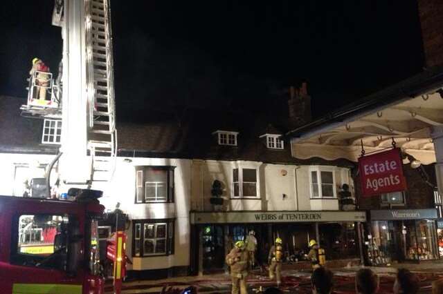 Fire crews scale the building with a height vehicle. Picture: Daniel Warren