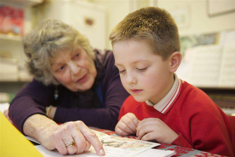 Jean Taylor with reading pupil Lewis Dryden, 6.