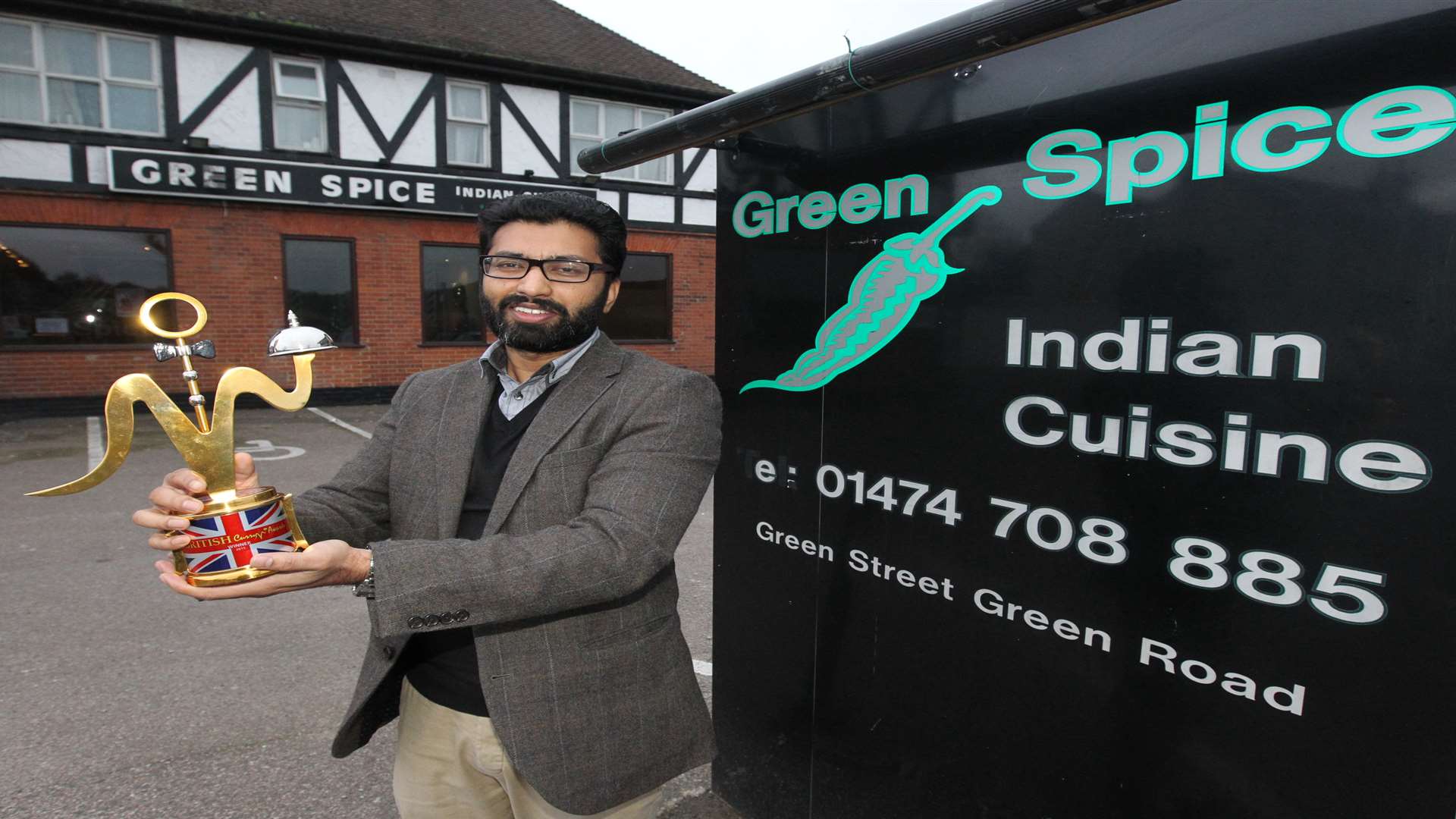Sam Islam, owner of The Green Spice proudly shows off his British Curry Award.