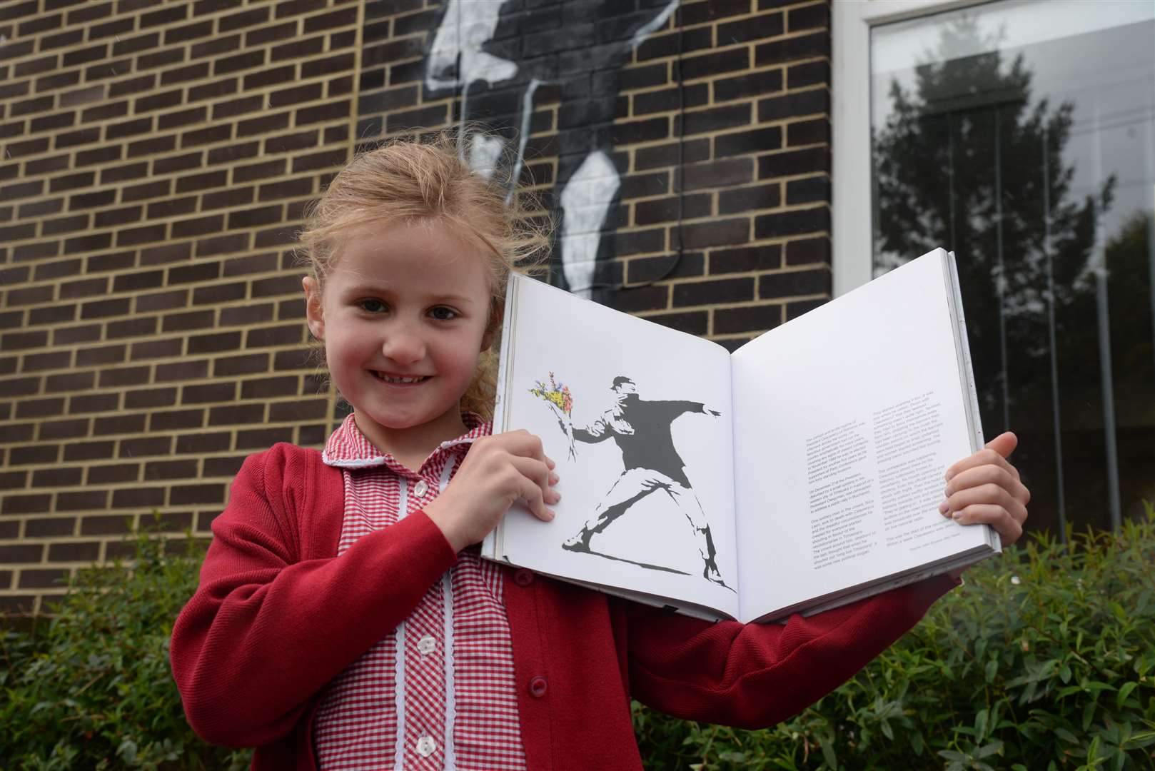 Amelie, six brought in a book about Banksy at Loose Primary School on Wednesday. Picture: Chris Davey. (9080201)