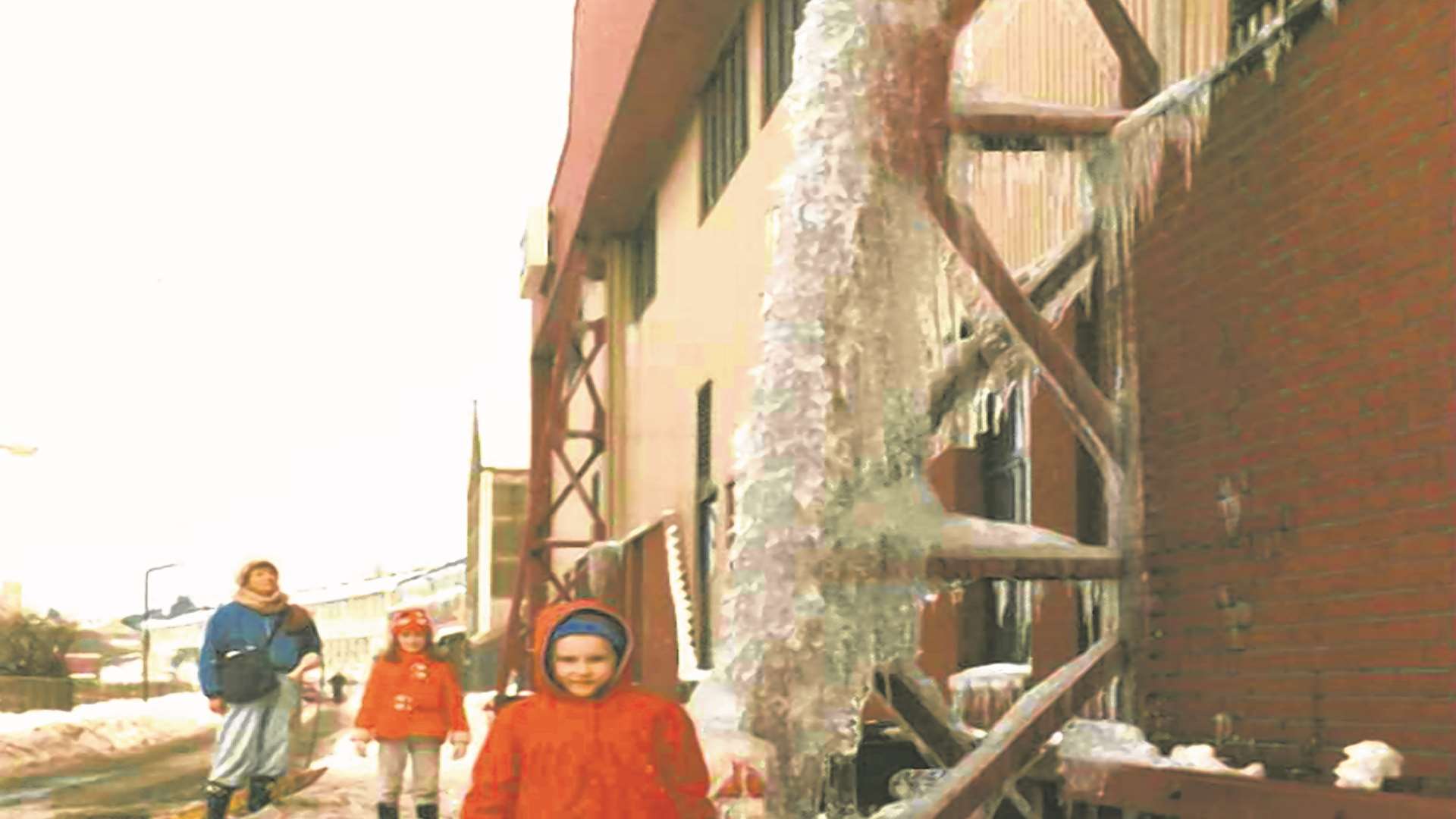 Andrea Everett, now Waite, admires a giant icicle in Rochester