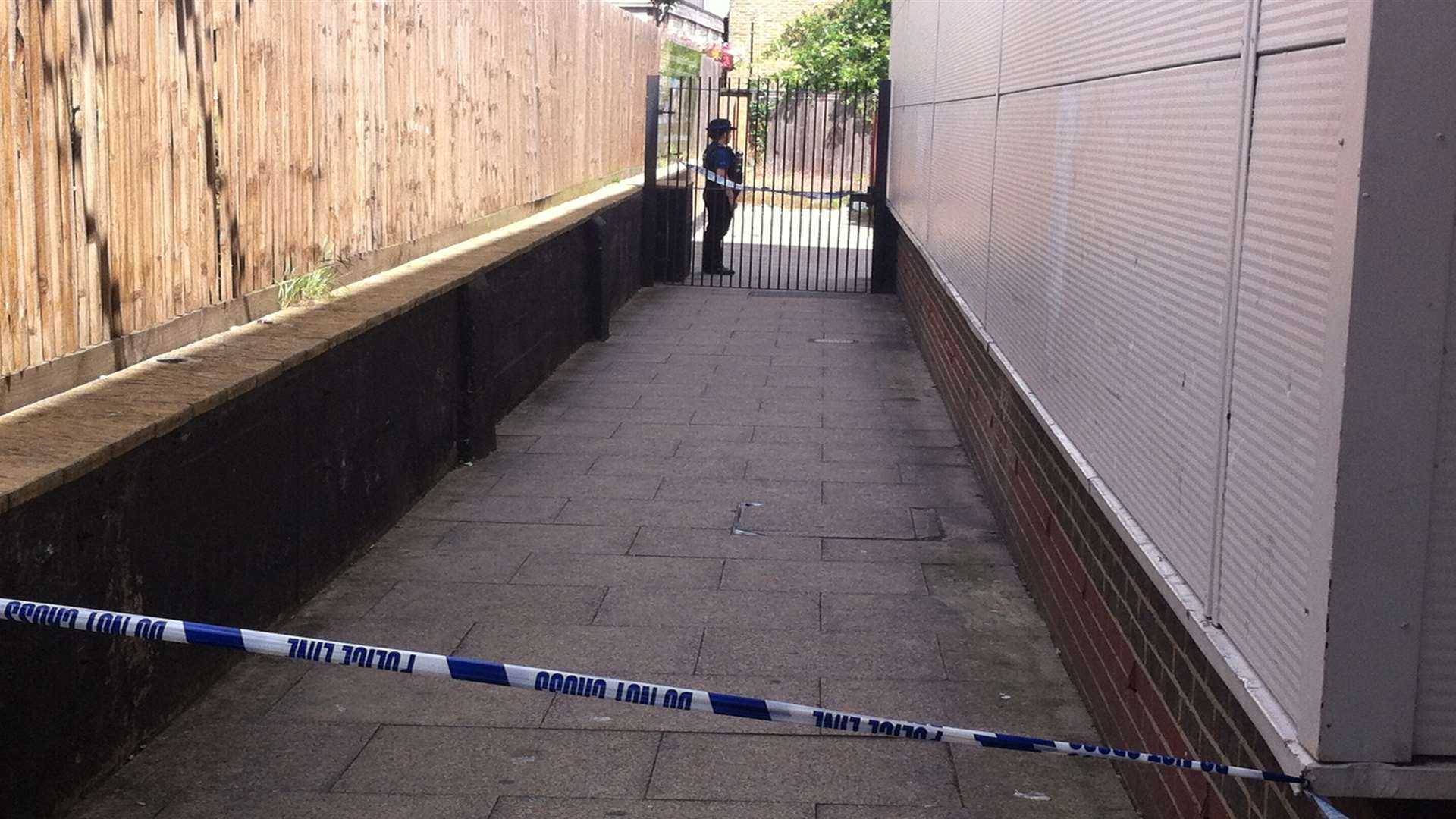 The police cordon included a gated alley beside Sainsbury's in Dartford