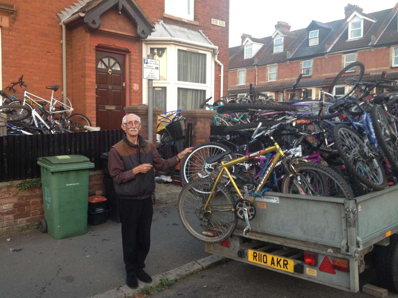 David Watts, 73, next to his collection of bikes that spill out onto the street