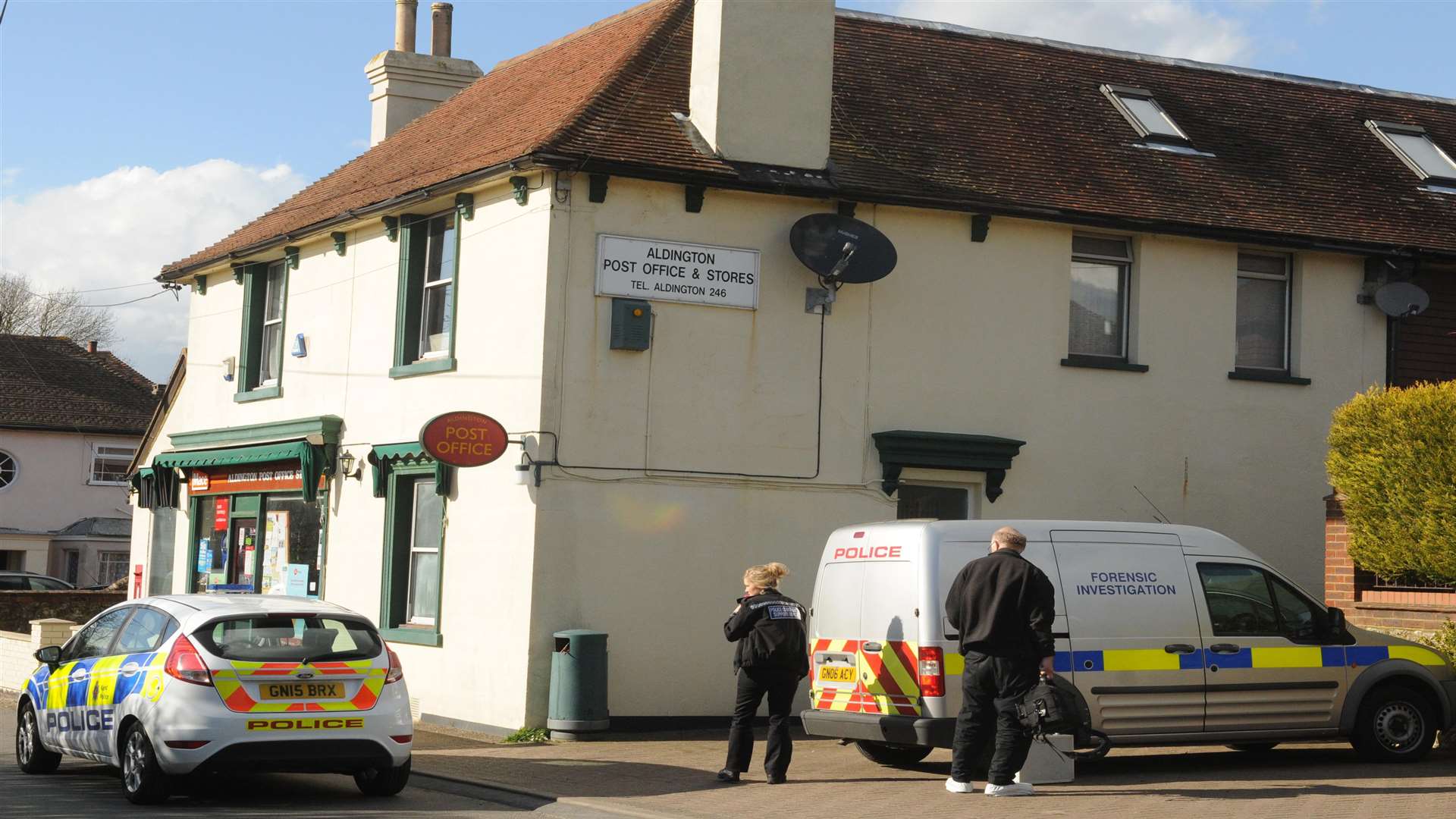 Police at the scene of the robbery at Aldington Post Office
