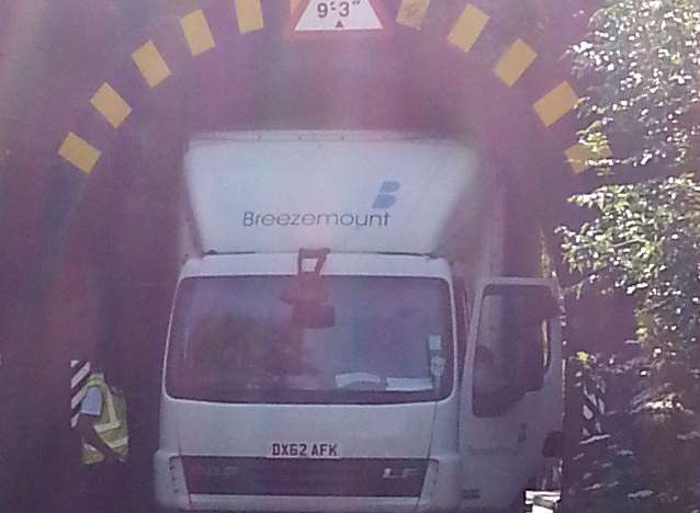 The lorry is stuck under a low bridge in Dowding Way. Photo by @Kent_999s