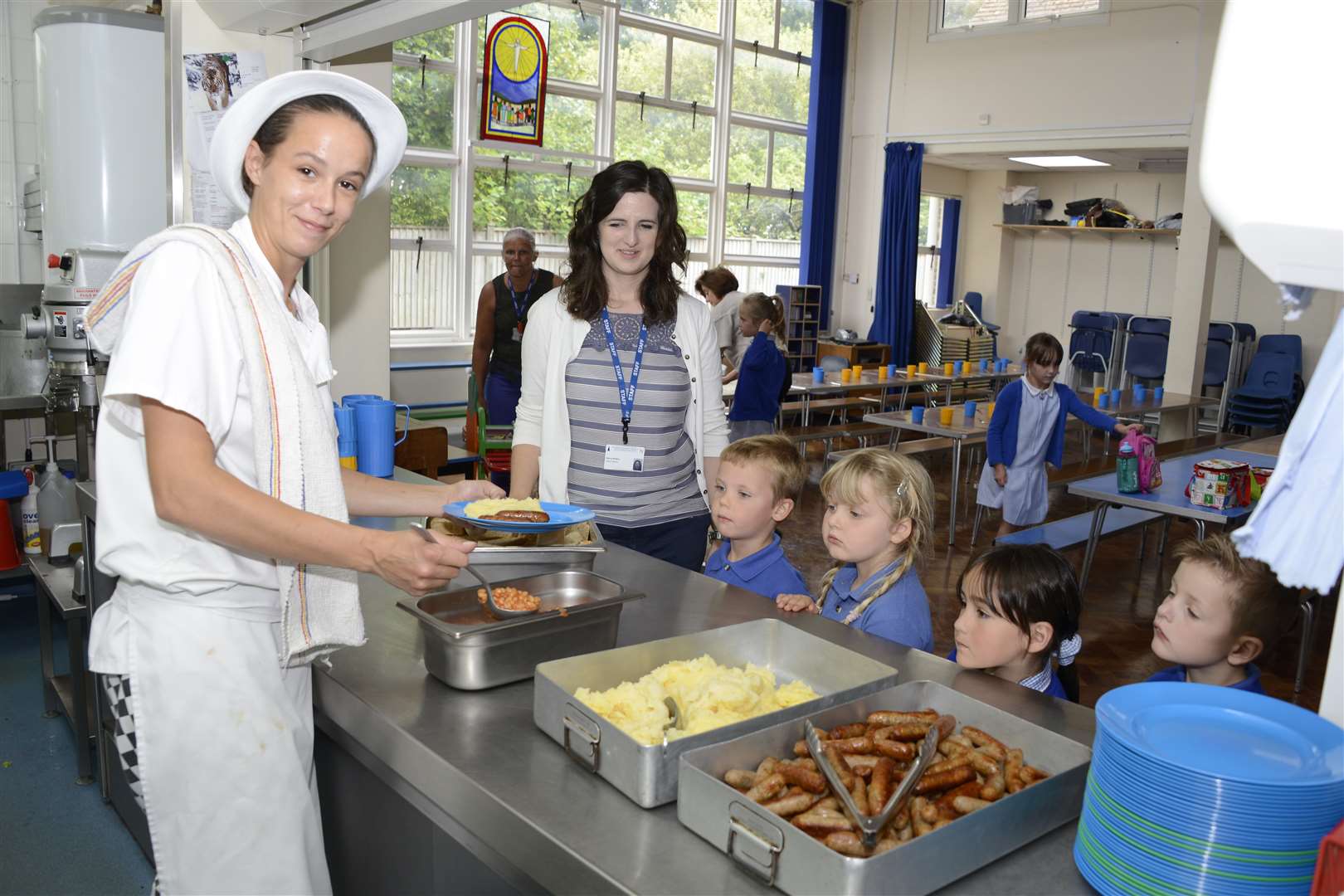 Whole School Meals celebrate 10 years of serving school dinners. Pictured with cook Vikki Boyce serving up lunch