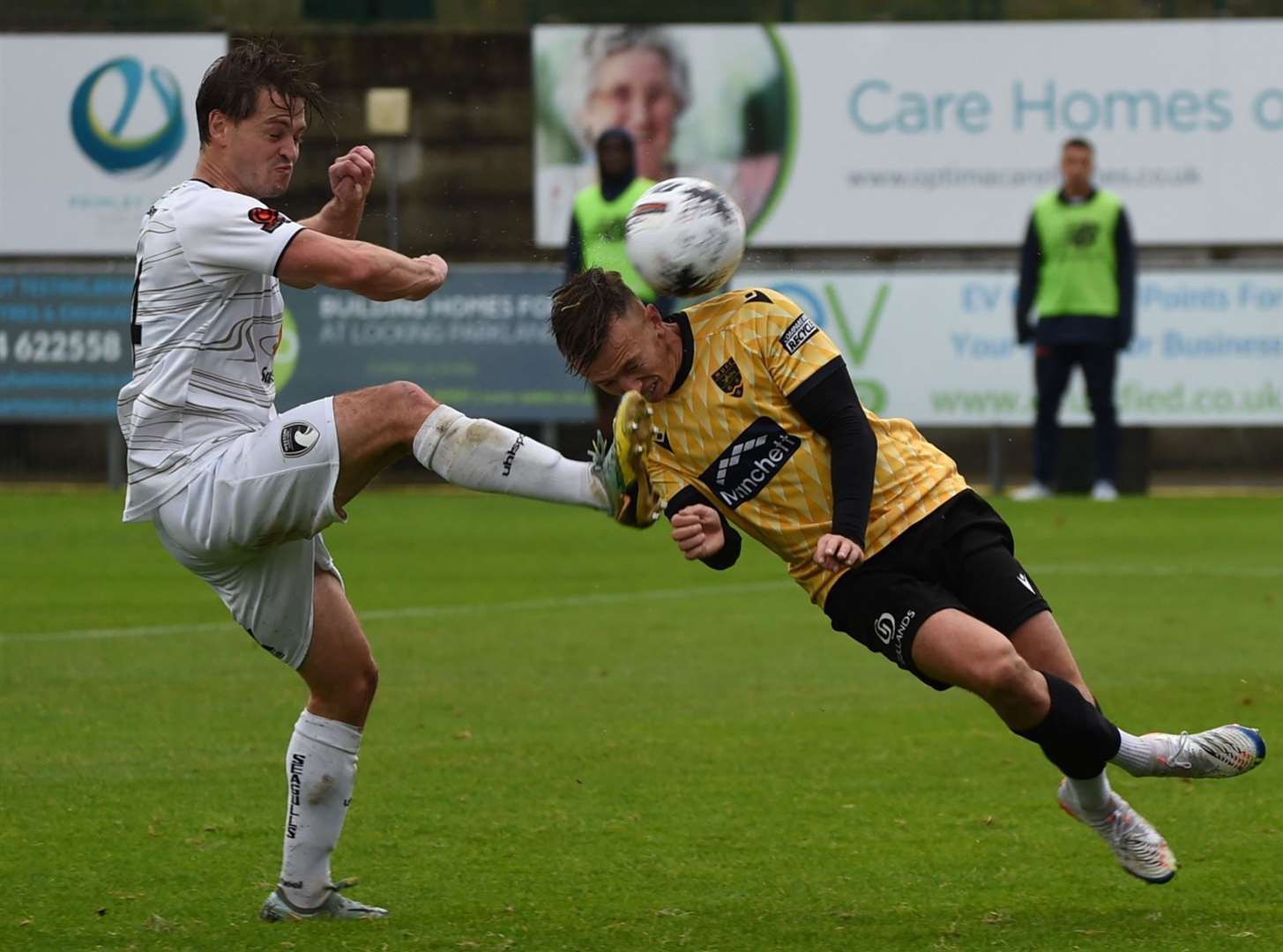 Maidstone United midfielder Sam Corne receives a whack during the 1-1 National League South draw at Weston Picture: Steve Terrell