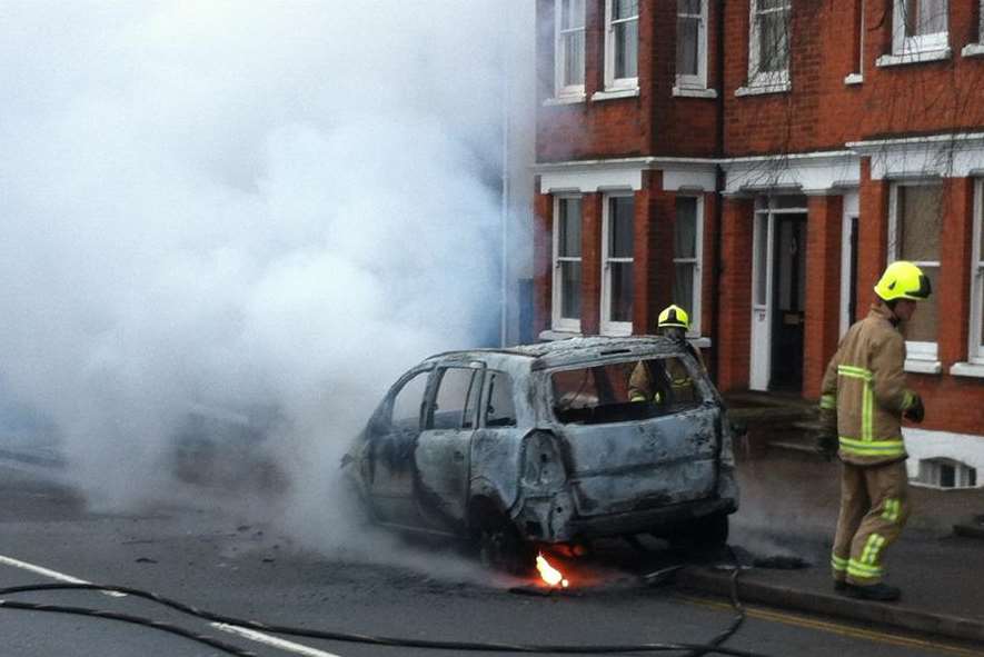 A firefighter tackles a blazing car in Maidstone. Picture: Brett Lewis