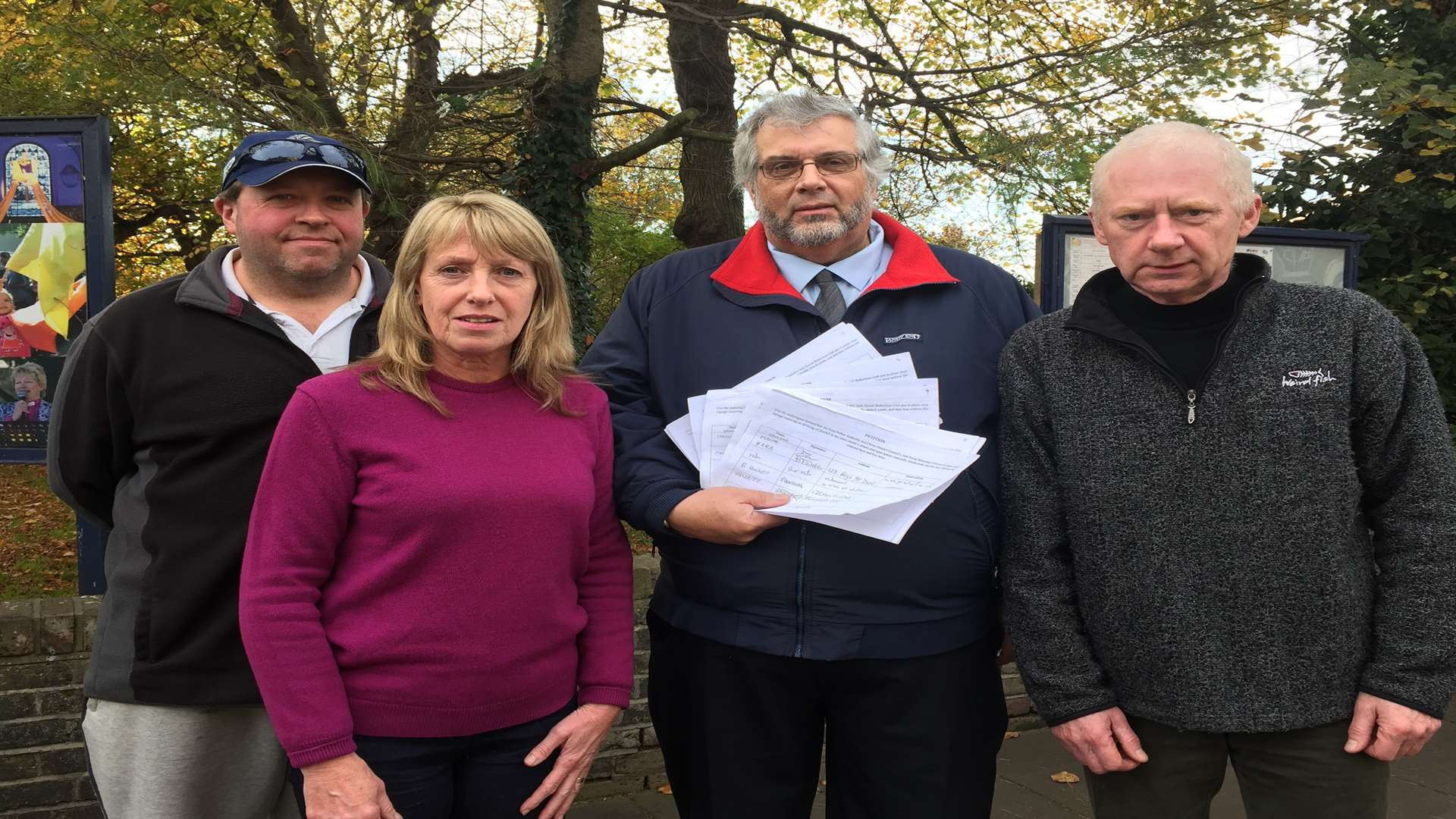 Shop owners Jason Down, Susan Birch and Myles Young with Cllr Mike Eddy holding the petition