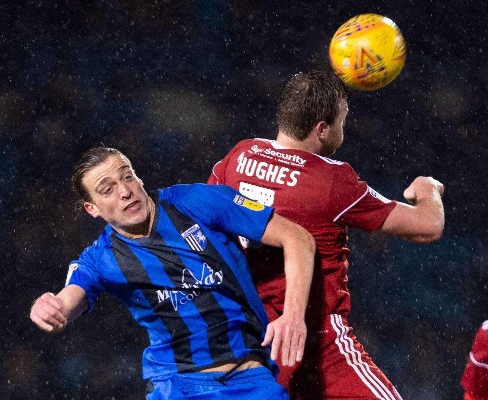 Gills striker Tom Eaves challenges with Accrington's Mark Hughes Picture: Ady Kerry