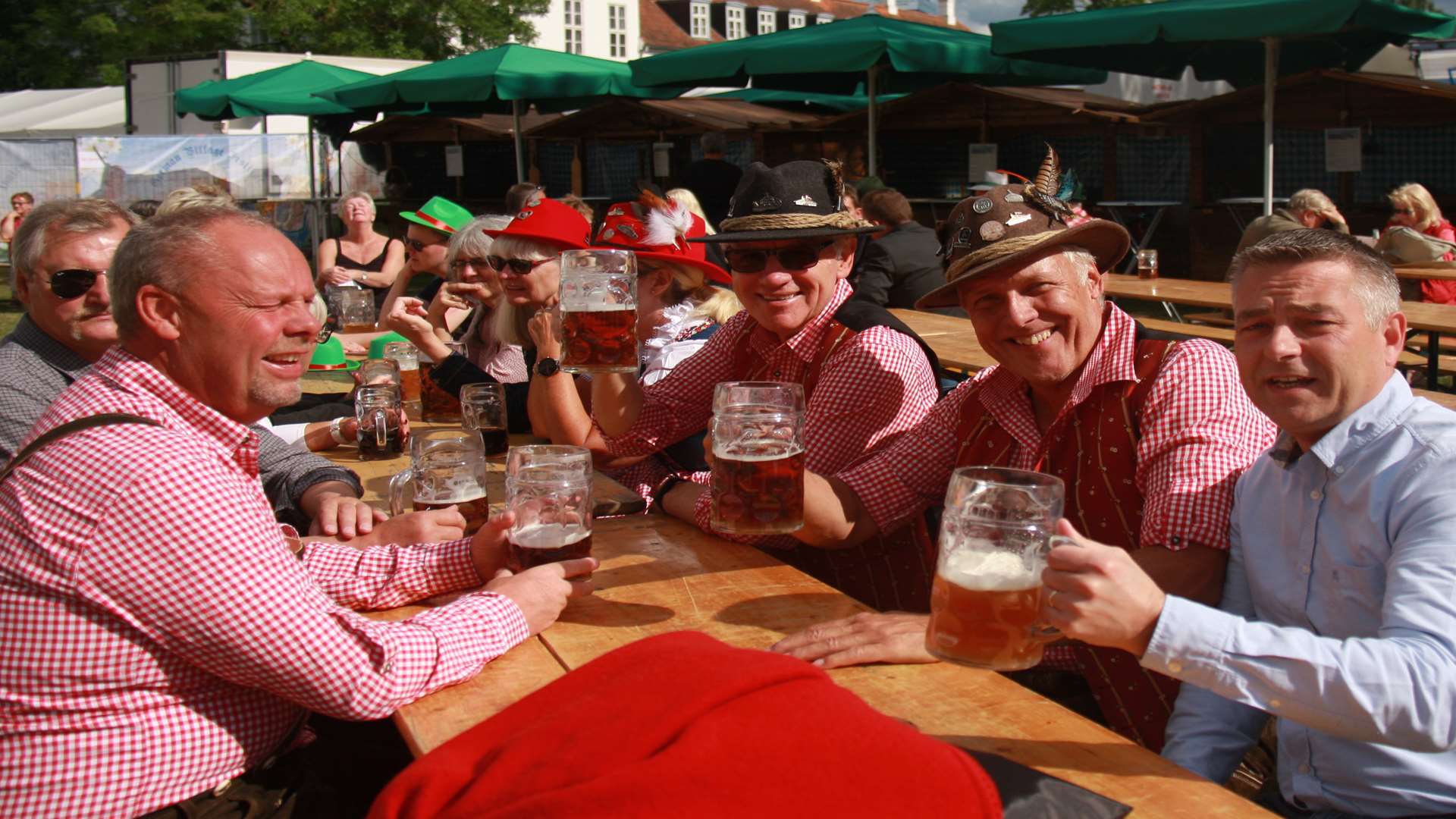 Guests enjoying a beer in a Bavarian style stein