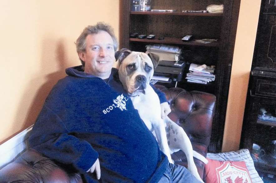 Gareth Davies at home with his dog Alfie last year. Picture: Clare Freeman.