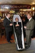 Landlord Colm Powell, in his coffin, with pub regulars Jon Everest, Graeme Pine and Cliff Rees. Picture by Matthew Walker