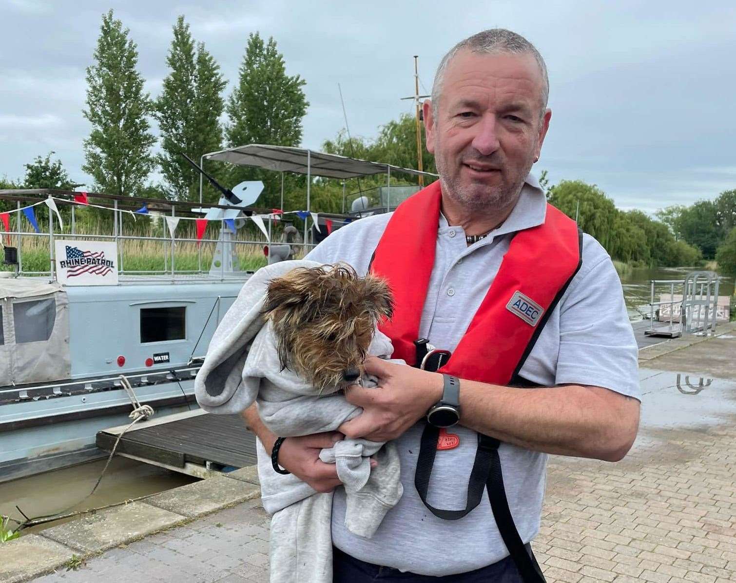 Wayne Goldfinch with the terrier rescued from the waters of the River Stour in Sandwich. Picture: River Runner